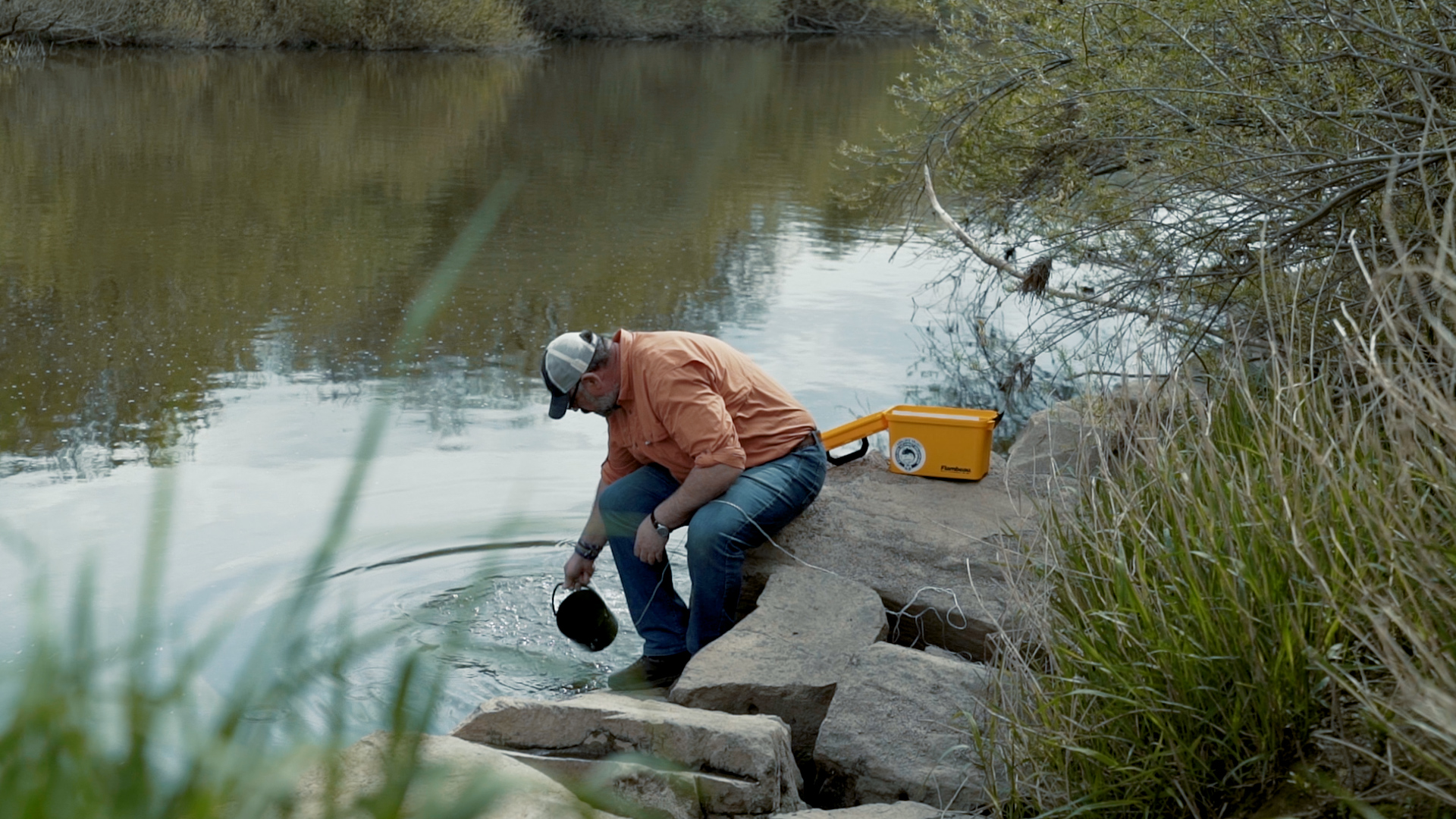 Taking a sample of river water to check its quality