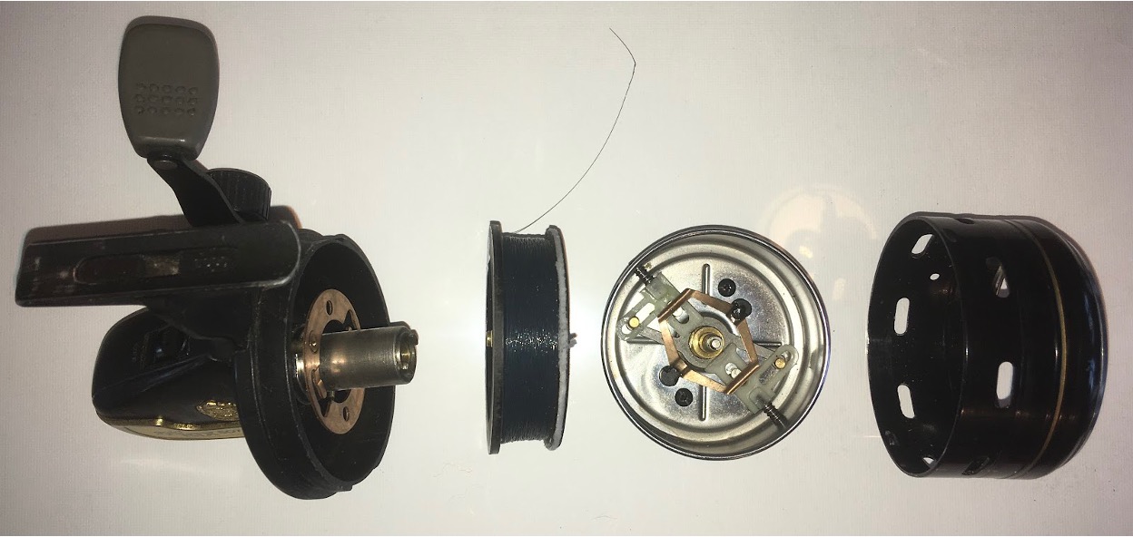 A partially dismantled closed-face reel. On the left is the main body that contains the gears. Working right we come to the spool which houses the line. Next we have the rotor which is the part that spins (the clue is in the name) and also houses the ‘pick up pins’ which are the devices that pop out to retrieve line and pop back in again when the button is pressed to allow line to peel off the spool. Finally, far right we have the cowl, sometimes called the shield or cover, that not only protects the rotor and spool but its main operational function is to keep the line close to the rotor so that it is always gathered up by the pick-up pins.