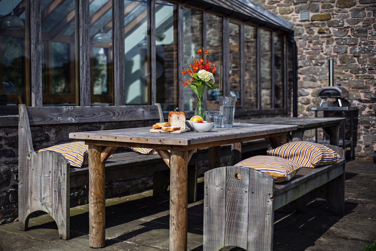 One of the picnic tabled in the courtyard at Cabalva Cwm Pelved