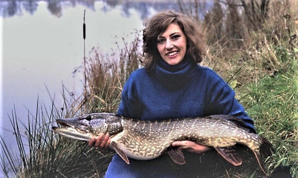 This pike could be older than the lady angler holding it
